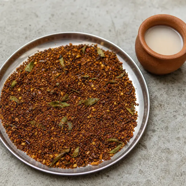Step 5: finished masala cooling on a steel tray beside the coconut vinegar pot